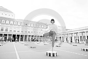 Beauty girl stand in yoga pose in paris, france. Beauty model pose in high heel shoes on column