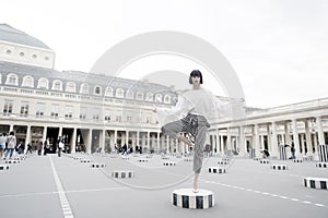 Beauty girl stand in yoga pose in paris, france. Beauty model pose in high heel shoes on column