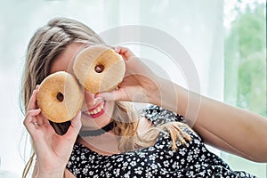 Beauty girl taking colorful donuts. Funny joyful woman with sweets, dessert