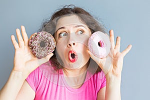 Beauty girl taking colorful donuts. Funny joyful woman with sweets, dessert. Diet, dieting concept. Junk food