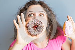 Beauty girl taking colorful donuts. Funny joyful woman with sweets, dessert. Diet, dieting concept. Junk food