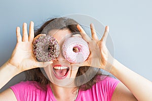 Beauty girl taking colorful donuts. Funny joyful woman with sweets, dessert. Diet, dieting concept. Junk food
