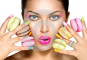 Beauty girl taking colorful macaroons