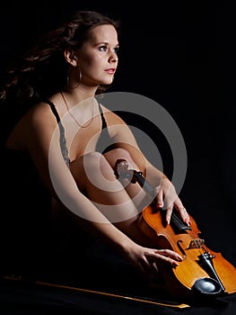 Beauty girl with violin look into the distance