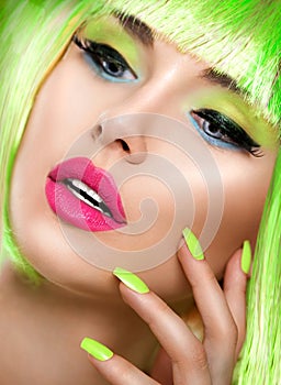 Beauty girl with vivid makeup and bright green nailpolish photo