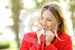 Beauty girl warmly clothed wearing red jacket in winter photo