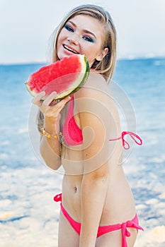 Beauty girl is wearing red swimsuit eating