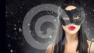 Beauty glamour brunette woman wearing carnival dark mask, party over holiday black background