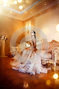 Beauty gorgeous woman in beautiful evening dress in luxurious style interior room