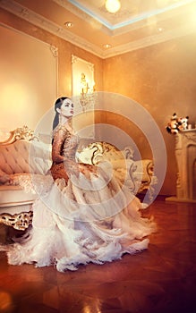 Beauty gorgeous woman in beautiful evening dress in luxurious style interior room