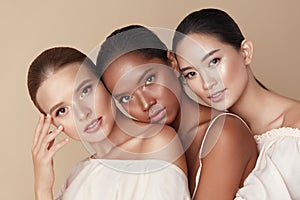 Beauty. Group Of Diversity Models Portrait. Multi-Ethnic Women With Different Skin Types Posing On Beige Background. Tender photo