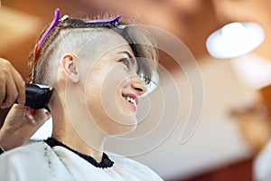 Beauty, hairstyle, treatment, hair care concept, young woman and hairdresser cutting hair at hairdressing salon.