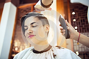 Beauty, hairstyle, treatment, hair care concept, young woman and hairdresser cutting hair at hairdressing salon. Hairdresser cutts