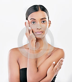Beauty, hand on face and portrait a Indian woman with natural skincare isolated on a white background. Dermatology