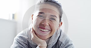 Beauty, happiness and laughter with a perfect young woman laughing and smiling at the camera. Closeup portrait of the