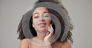 Beauty and healthcare concept - beautiful African American woman with curly afro hairstyle and clean, healthy skin