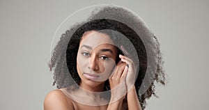 Beauty and Healthcare concept - Beautiful African American woman with curly afro hairstyle hair and clean, healthy skin