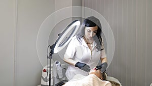 Beauty injections. Lip augmentation procedure. Lip injection plastic surgery. The cosmetologist in medical gloves