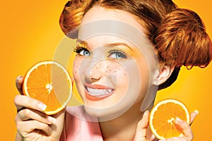 Beauty joyful teen girl with juicy oranges