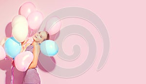 Beauty joyful teenage girl with colorful air balloons having fun