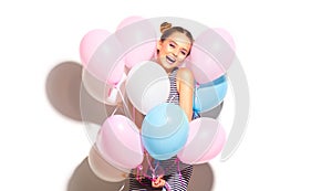 Beauty joyful teenage girl with colorful air balloons having fun