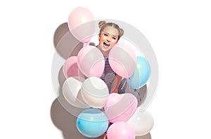 Beauty joyful teenage girl with colorful air balloons having fun