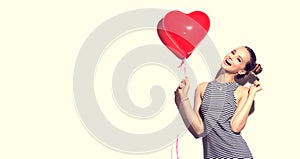 Beauty joyful teenage girl with heart shaped air balloon