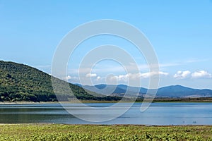 Beauty look toward picturesque Rabisha lake and mountain over Magura cave