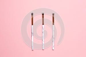 Beauty make up brushes on a pink background