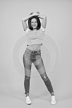 Beauty and make up. Skinny jeans suits her. Self confidence is best outfit. Sexy girl yellow background. Sexi girl