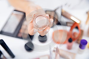 Beauty makeup artist holds palette with powder, conducts online tutorial on choosing cosmetics, top view