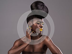 Beauty, makeup and black woman in studio with lipstick, cosmetics and eyeshadow on gray background. Creative, aesthetic