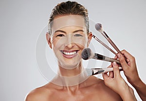 Beauty, makeup and cosmetic brush by a senior woman face with a happy smile in a studio. Portrait of a elderly person