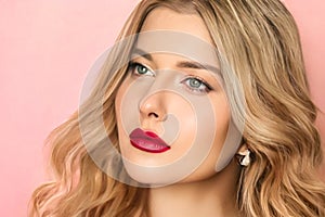 Beauty, makeup and curly hairstyle, beautiful blonde woman with red matte lipstick make up on pink background as bridal