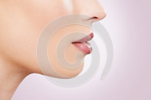 Beauty, makeup and lipstick with woman closeup in studio on purple background for mouth cosmetics. Skincare, lips and