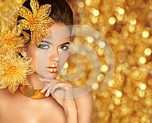 Beauty Makeup, luxury jewelry. Fashion glamour girl model portrait with flowers isolated on golden lights bokeh holiday