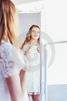 Beauty makeup morning rutine love yourself concept. Young teenage girl looking at reflection in mirror. Young positive woman