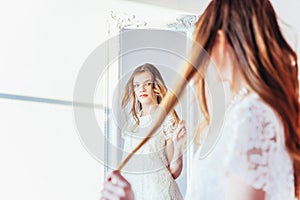 Beauty makeup morning rutine love yourself concept. Young teenage girl looking at reflection in mirror. Young positive woman