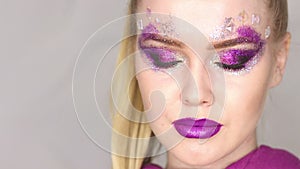 Beauty Makeup. Purple Make-up and Colorful Bright Nails. Beautiful Girl Close-up Portrait