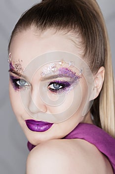 Beauty Makeup. Purple Make-up and Colorful Bright Nails. Beautiful Girl Close-up Portrait