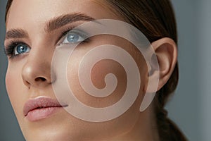 Beauty makeup. Woman face with eyes and eyebrows make-up