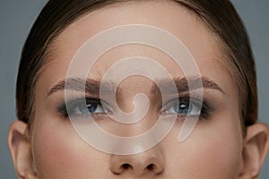 Beauty makeup. Woman face with eyes and eyebrows make-up