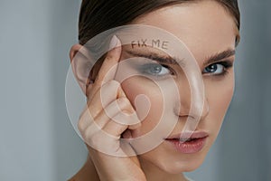 Beauty makeup. Woman face with messy eyebrow and fix me on skin