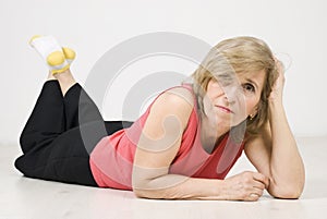 Beauty mature woman posing on floor