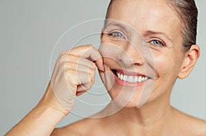 Beauty mature woman pulling perfect skin