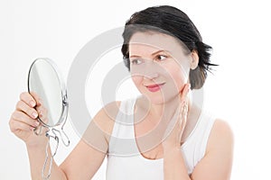 Beauty middle age woman with mirror. Face portrait. Spa and anti aging concept Isolated on white background. Plastic surgery