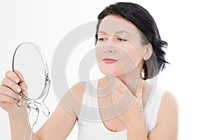 Beauty middle age woman with mirror. Face portrait. Spa and anti aging concept Isolated on white background. Plastic surgery