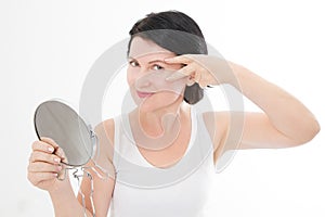 Beauty middle age woman with mirror. Face portrait. Spa and anti aging concept Isolated on white background. Plastic surgery