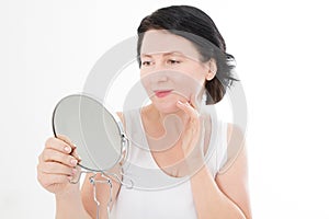 Beauty middle age woman with mirror. Face portrait. Spa and anti aging concept Isolated on white background. Plastic surgery