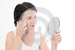 Beauty middle age woman with mirror. Face portrait. Spa and anti aging concept Isolated on white background. Plastic surgery